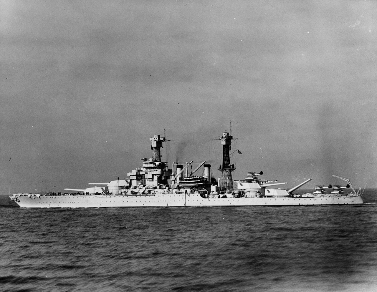 Black and white photograph of the battleship USS Colorado in the 1930s with Vought O3U-3 Corsair floatplanes on her catapults.