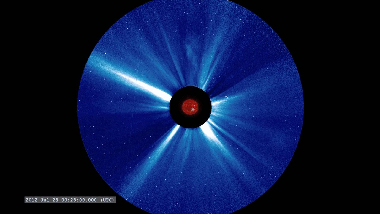 A bright cloud of solar material blasting outward from the masked disk of the Sun, seen by a coronagraph